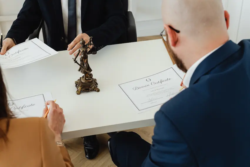 Legal documents and a pen on a wooden desk representing estate planning preparation