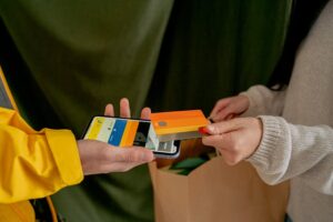 Consumer making a contactless payment with a credit card, symbolizing smart 0% APR balance transfer card usage.