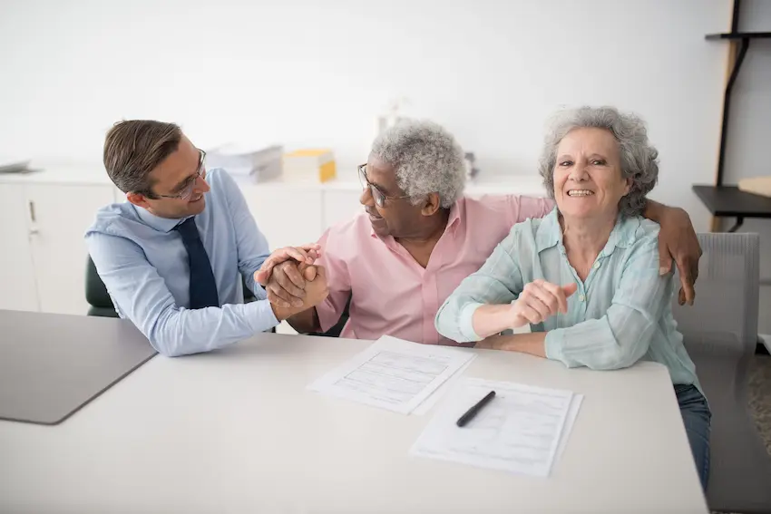 Elderly couple reviewing genworth long term care insurance documents at home