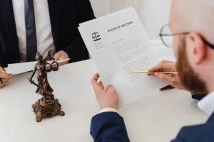 Professional reviewing legal documents at a desk, illustrating the careful work of a mergers and acquisitions attorney.