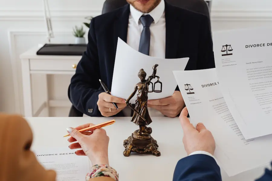 Self-employed professional reviewing health insurance paperwork at a home office desk