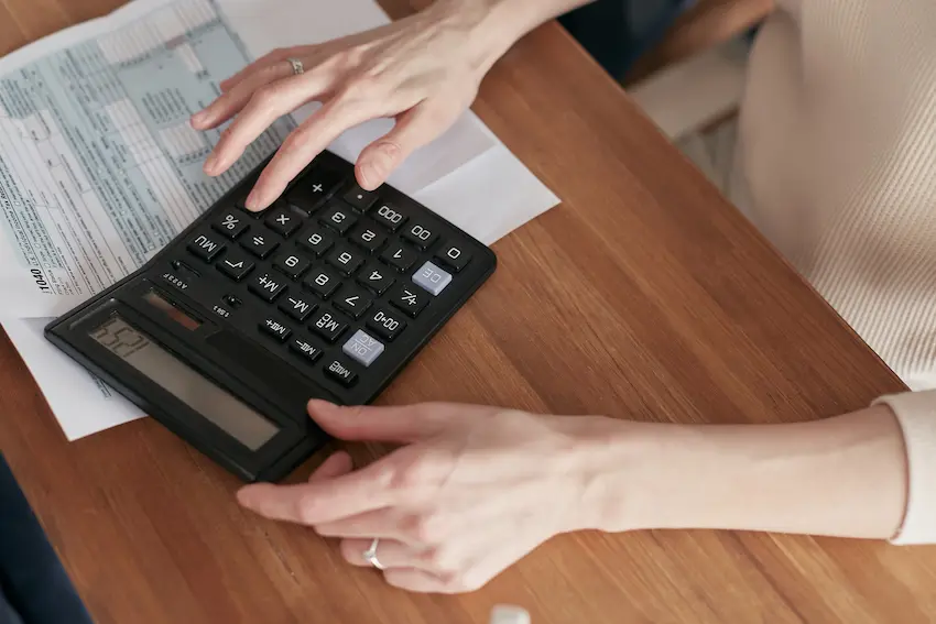 Calculator and financial documents on a desk representing tax attorney services and IRS tax dispute resolution