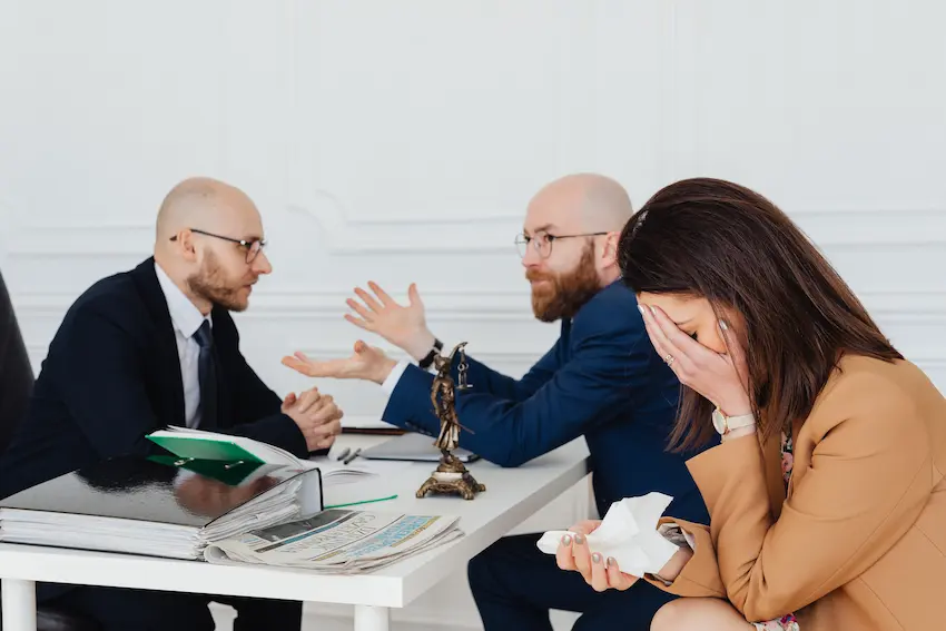 wrongful termination lawyer reviewing employment case documents at a desk