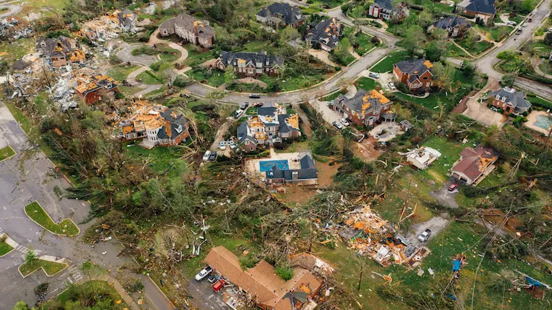 Aerial view of a neighborhood with severe storm damage, highlighting the need for hurricane insurance in coastal areas.