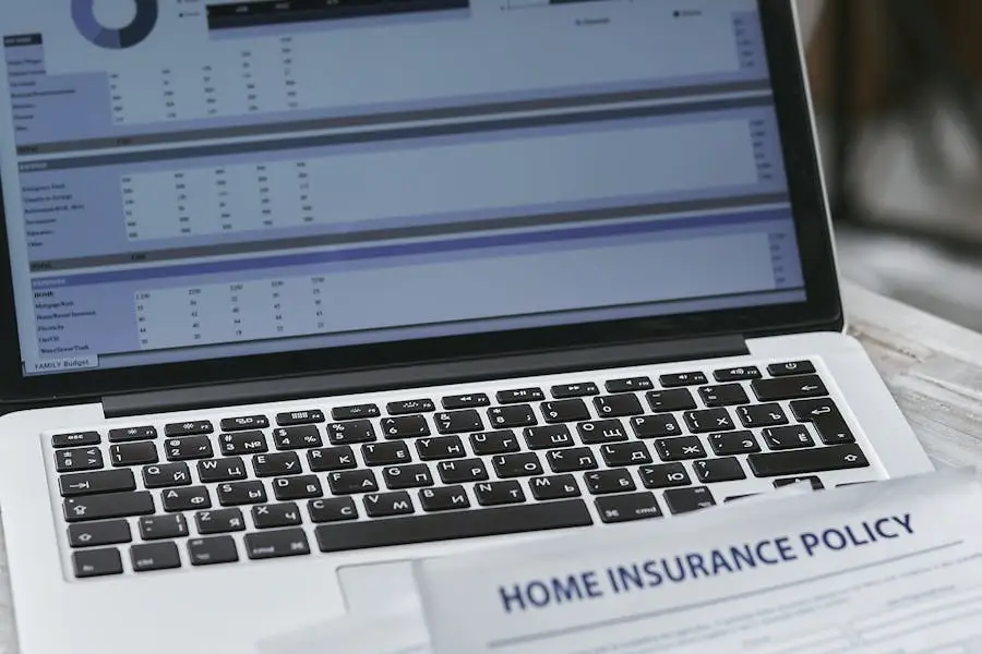 Laptop displaying a budget next to an insurance policy, highlighting financial planning for renters.