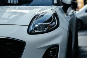 Close-up of a new white car with rain droplets, highlighting U.S.-assembled vehicle eligibility for tax deductions. (Car Loan Interest Deduction Do You Qualify in 2026.webp)