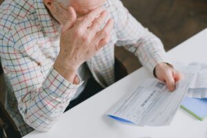 Senior man reviewing tax paperwork, illustrating how the new $6,000 deduction can help ease financial stress. (New $6,000 Senior Tax Deduction Who Qualifies.jpg)