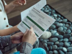 A close-up shot of two people reviewing a financial document titled "Return on Investment," featuring data tables and charts, suitable for an article comparing Roth and Traditional IRA retirement investment accounts.