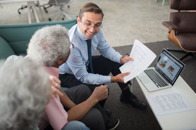 "A financial advisor explaining retirement planning documents to a senior couple."